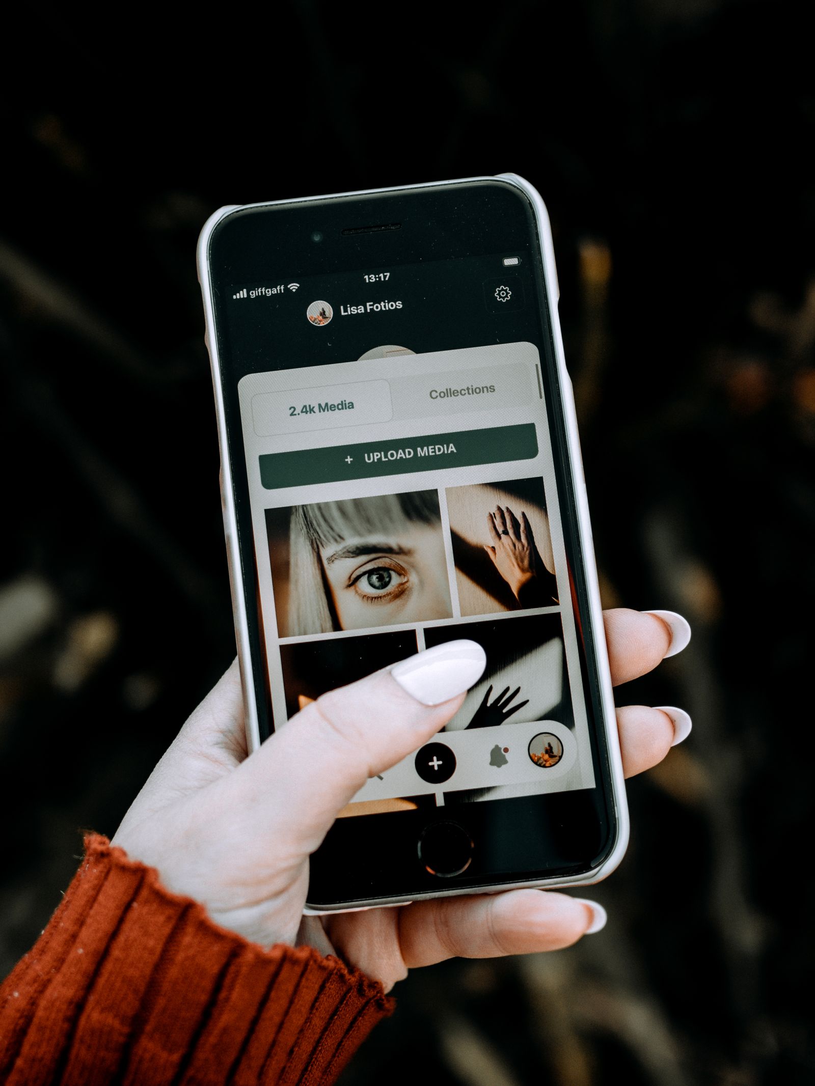 Hand holding a phone with an app on screen